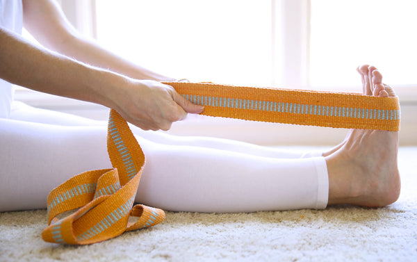 handmade yoga straps being used by student of yoga