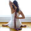 hand dyed and handwoven yoga strap being used by student of yoga